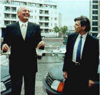 Henry Cooper laughing as he presents me with a car.  